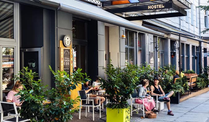 People sitting at tables at sidewalk terrace outside of Circus Hostel, Berlin